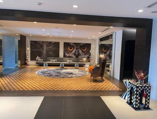 Relax in a stylish living area with a sofa, armchairs, and abstract art.
