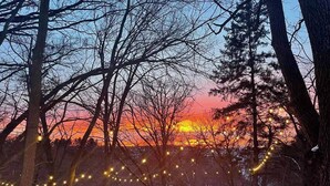 A snowy outdoor area with string lights and a wooden structure. - Otter Creek Manor - Oversized 3bd, 1.5 Ba. 3 acres, creek access. (Eau Claire)