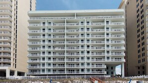A multi-story hotel with a uniform exterior, featuring balconies on each floor.