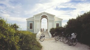A coastal house with a porch and bicycles parked in front. - Pet Friendly, 150 Yards to Pool, 1 Min to the Beach, Shopping and Dining (Santa Rosa Beach)