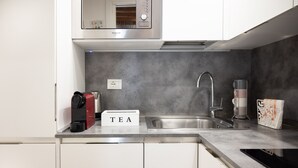 A modern kitchen with a stainless steel sink, a coffee machine, and a tea station. - Milano Suite Home - Your home in Milan! (Milano)