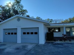 A single-story building with a garage and a covered porch.