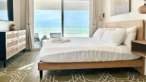 A bedroom with a bed, a desk, a chair, and a view of the ocean. - Beachfront 1 Bedroom/Pool/Kitchen/Breakfast/550SF (San Pedro)