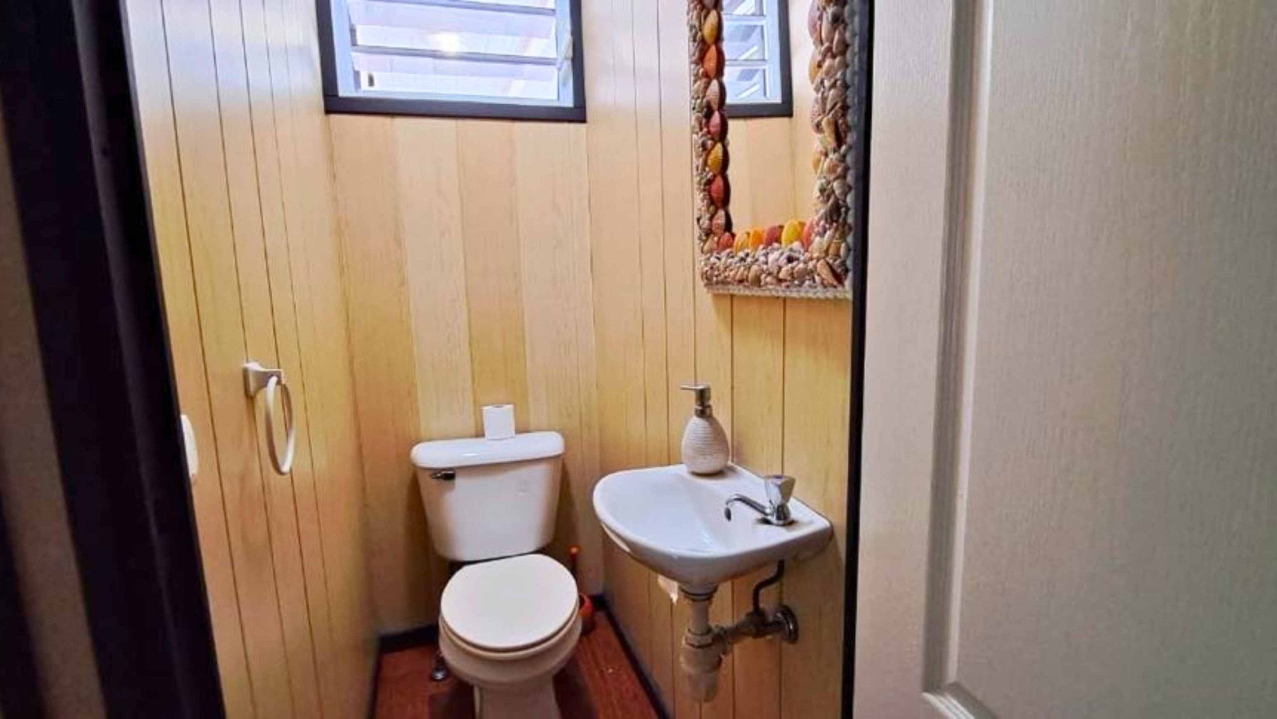 A small bathroom with a toilet and a sink.