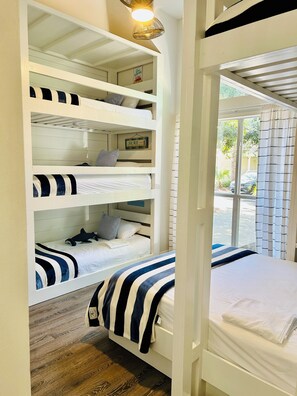 A multi-level bunk bed room with a view of the outdoors. - Golf Cart to Beach + Walk to Pool + Park 4 SUVs (Destin)