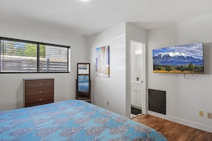 A bedroom with a bed, dresser, and a painting of a mountain landscape. - Flagstaff Getaway Triplex 6 Bedrooms, 4.5 Baths, Fenced Yards, AC, 3-Car Garage (Flagstaff)