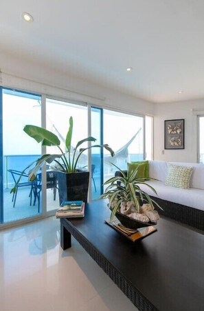 Relax in this ocean-view living area with a comfortable sofa and coffee table.