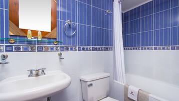 A bathroom with a white sink, a toilet, and a bathtub.