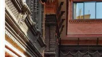A multi-story building with ornate balconies and traditional architectural details.