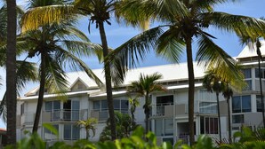 A multi-story hotel with balconies and large windows. - Résidence de la vieille tour  (Le Gosier)
