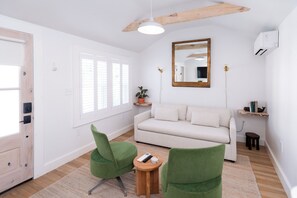 Chambre quadruple luxueuse, patio | Aire de séjour | Téléviseur