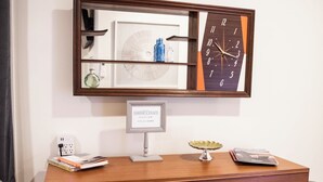 A wooden dresser with drawers, a mirror with a clock, and a sign reading 'Cooper's Pointe.' - Suite 104 freatures a private outdoor-covered balcony. (Cherokee Village)