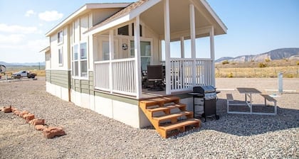Our largest "not so tiny" tiny home, White River Casita is a beautiful modern tiny home that features a Queen bed on main level, one Queen bed in loft accessible by stairs, one Queen fold out couch with additional sleeping space in loft for sleeping