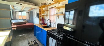 Our newest and one of our largest tiny homes contains a queen bed on the main level and two queen lofted beds. Sleeps: 6