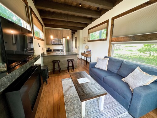 Luxury Accommodation. Bedroom with queen bed. Sleeper sofa in living area. Full bath with shower. Kitchen. Living area with TV and Fireplace. Washer/Dryer.