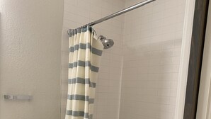 A walk-in shower with a glass door, a shower curtain, and a bathtub. - Private Quaint Cozy Room (Denver)