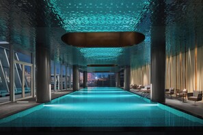 A modern indoor swimming pool with a clear view of the cityscape through large windows. - Hotel Indigo Ningbo Riverside by IHG (Ningbo)