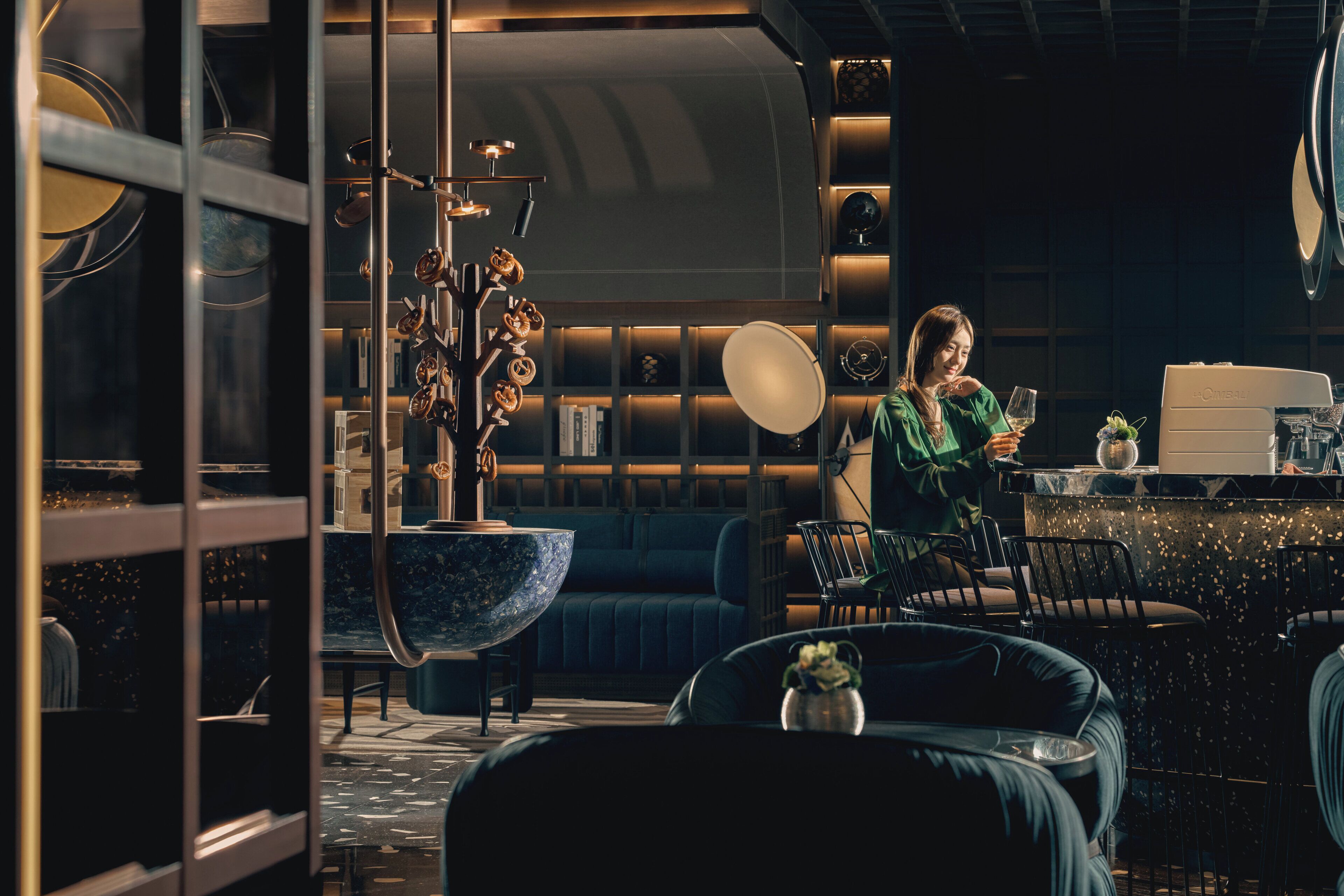 A modern interior with a bar area, seating, and a large decorative bowl.