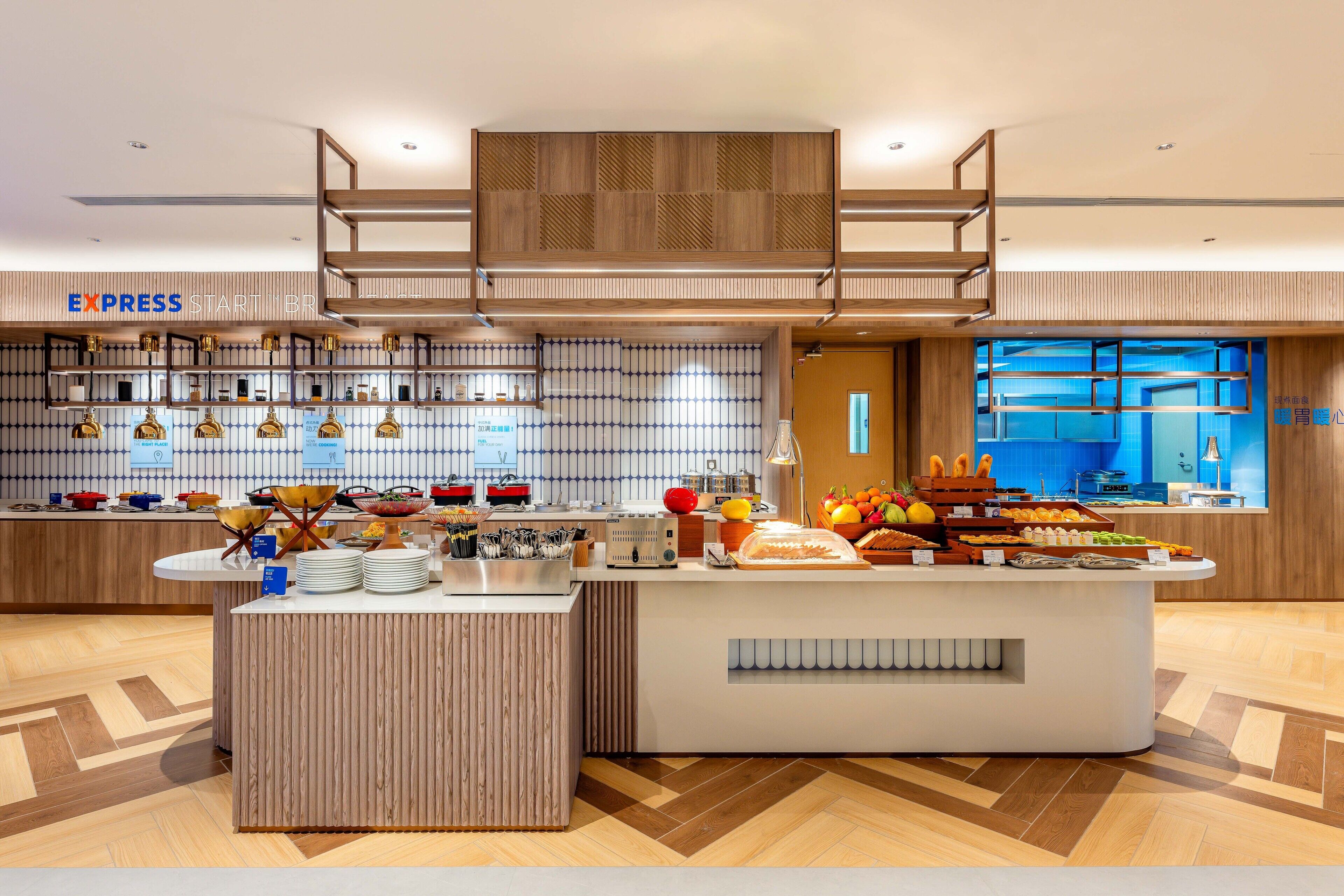 A modern breakfast bar with a variety of food items and a coffee station.