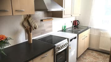 Family Condo (Winter) | Private kitchen | Electric kettle, highchair, cleaning supplies, dining tables