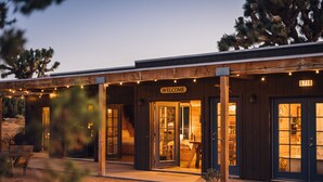 A building with a 'WELCOME' sign, wooden exterior, and a number '8710' on the door. - Joshua Tree Hidden Tower - View - Landmark - Across from National Park - Pets OK (Yucca Valley)
