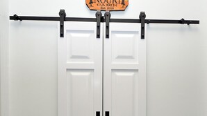 A white sliding door with a sign above it that reads "Welcome to the NOURI CABIN Est. 2016". - Black Bear Cabin - The Mountain Retreat! (Berkeley Springs)