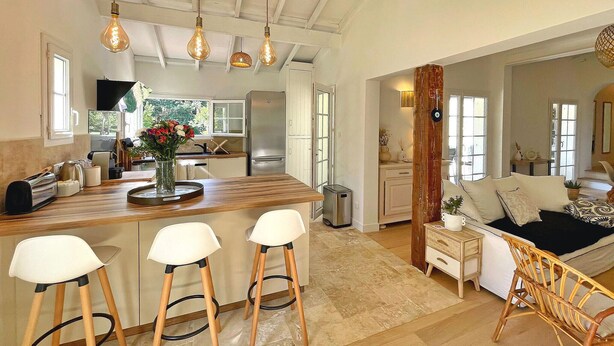 A spacious kitchen with a wooden island, bar stools, and hanging light fixtures. - Lovely home in Nans-Les-Pins (Nans-Les-Pins)
