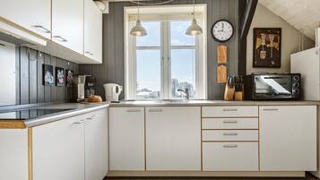 Coffee/tea maker, fridge, stovetop, cookware/dishes/utensils