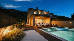 A modern house with a swimming pool, outdoor seating, and a well-lit patio area. - Stunning home in Bribir with private swimming pool, can be inside or outside (Bribir)