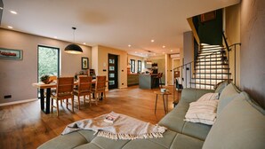 A spacious living area with a sofa, dining table, and chairs. A staircase leads to an upper level. - Stunning home in Bribir with private swimming pool, can be inside or outside (Bribir)
