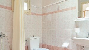 Ein Badezimmer mit Toilette, Dusche und Waschbecken.