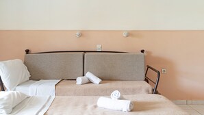 A bed with a headboard, pillows, and rolled towels. - Studio 'Sandy Maria Studio 503' with Shared Pool, Wi-Fi (Zante)