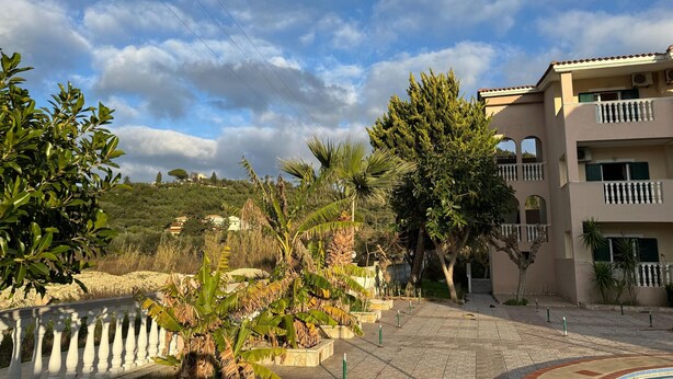 A residential area with a paved walkway, a pool, and a building with balconies. - Studio 'Sandy Maria Studio 705' with Shared Pool, Wi-Fi (Zante)