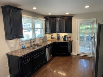 Granite counters and stainless appliances await in the kitchen. 