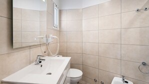 A modern bathroom with a white sink, a toilet, and a shower area. - Vacation Studio 'Las Flores 407' with Sea View, Shared Pool and Wi-Fi (Costa Adeje)