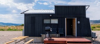 This Tiny Home is custom made by a Colorado craftsman has one Queen bed in loft accessible by stairs and also has a fold out Full futon on main level. Sleeps up to 4. Please note, this home does have a sleeping area in a loft. If you require an accom