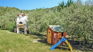A children's play area with a slide and a small building structure.
