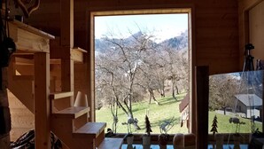 A wooden cabin interior with a large window overlooking a snowy landscape. - Gorgeous home in Onnion with WiFi (Onnion)