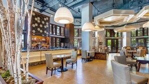 A spacious indoor area with a bar, seating, and large windows. - Luxury Amenities in Canyons!  Ski-in/Ski-out, Amenities, In-room dining (Park City)