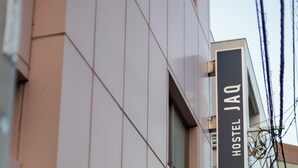 A Hostel JaQ sign and a vertical sign for Hostel JaQ on a building. - Hostel JAQ takamatsu (Takamatsu)