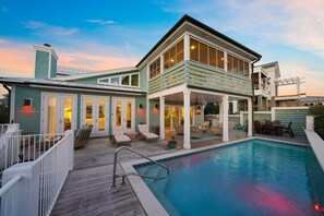 Relax in style on the covered patio, surrounded by a well-maintained pool area.