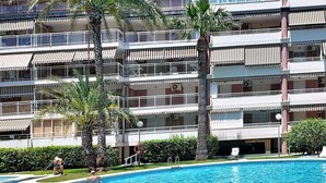 A multi-story hotel with balconies, a swimming pool, and palm trees. - Dianium by Interhome (Dénia)