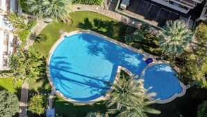 An aerial view of a resort with a large swimming pool surrounded by palm trees and a stone pathway. - Dianium by Interhome (Dénia)