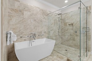 A modern bathroom with a freestanding bathtub, a glass-enclosed shower, and marble walls. - 🌊Walk to Beach-Great Location-4BR Pet Friendly Beachwaves Driftwood🌊 (Miramar Beach)