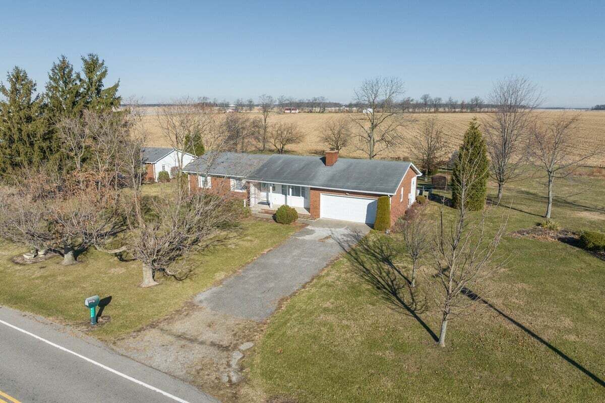 A single-story house with a garage, a driveway, and a lawn.