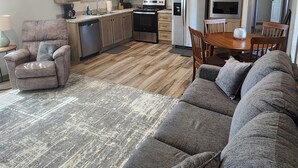A compact living space with a kitchenette, a sofa, a dining table, and a chair. - Cozy cottage w/1 bedroom, WiFi, AC in tranquil Springville close to boat ramps (Springville)