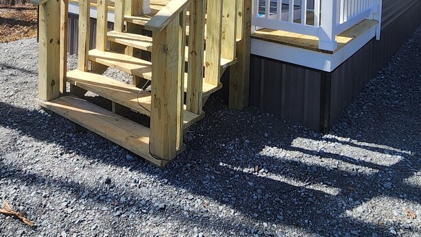 A small, single-story wooden structure with a porch and a staircase leading to a door. - Cozy cottage w/1 bedroom, WiFi, AC in tranquil Springville close to boat ramps (Springville)