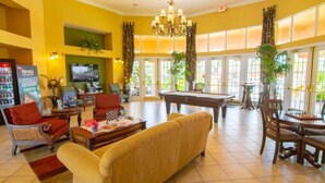 A spacious living area with a pool table, comfortable seating, and a television. - New! Lesa's Disney Vacation Home (Davenport)