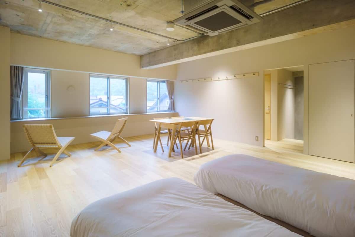 A room with a bed, a table, and chairs.