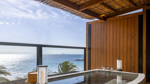 A modern bathroom with a freestanding bathtub, a glass-enclosed shower, and a view of the ocean. - izukaorukaze (Shimoda)